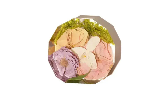 A 12 sided propagator vase made of clear resin preserving wedding flowers.