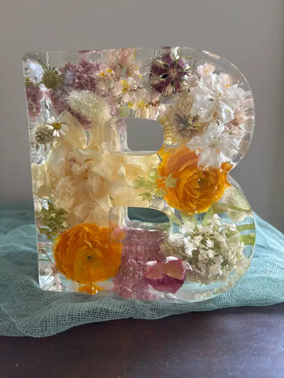 Large B letter resin block with white and orange wedding flowers