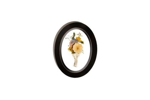 Oval Rubbed Black wooden frame displaying pressed groom Boutonniere.