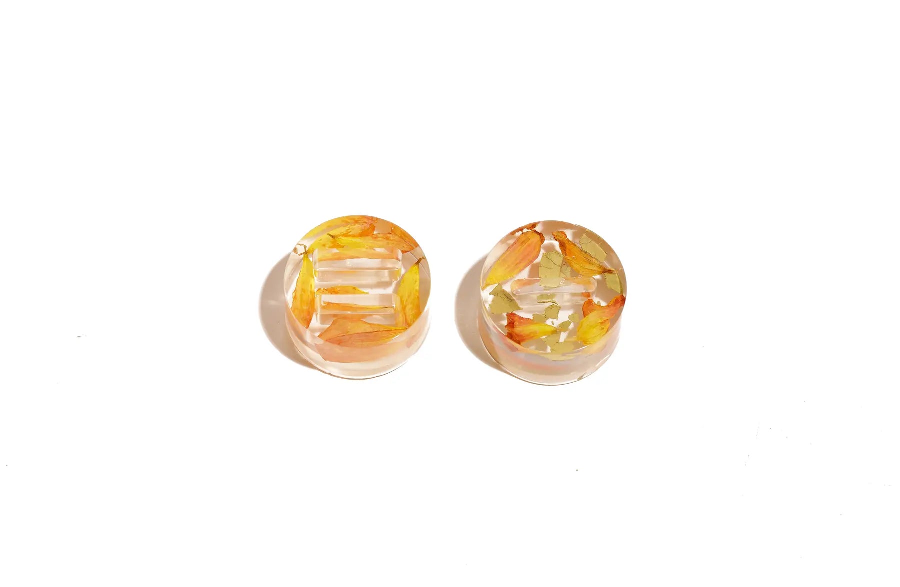Two Mini Circle Ring Stands with wedding flowers preserved in clear resin.
