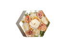 Pink carnations preserved in a clear resin bouquet block in a hexagon shape