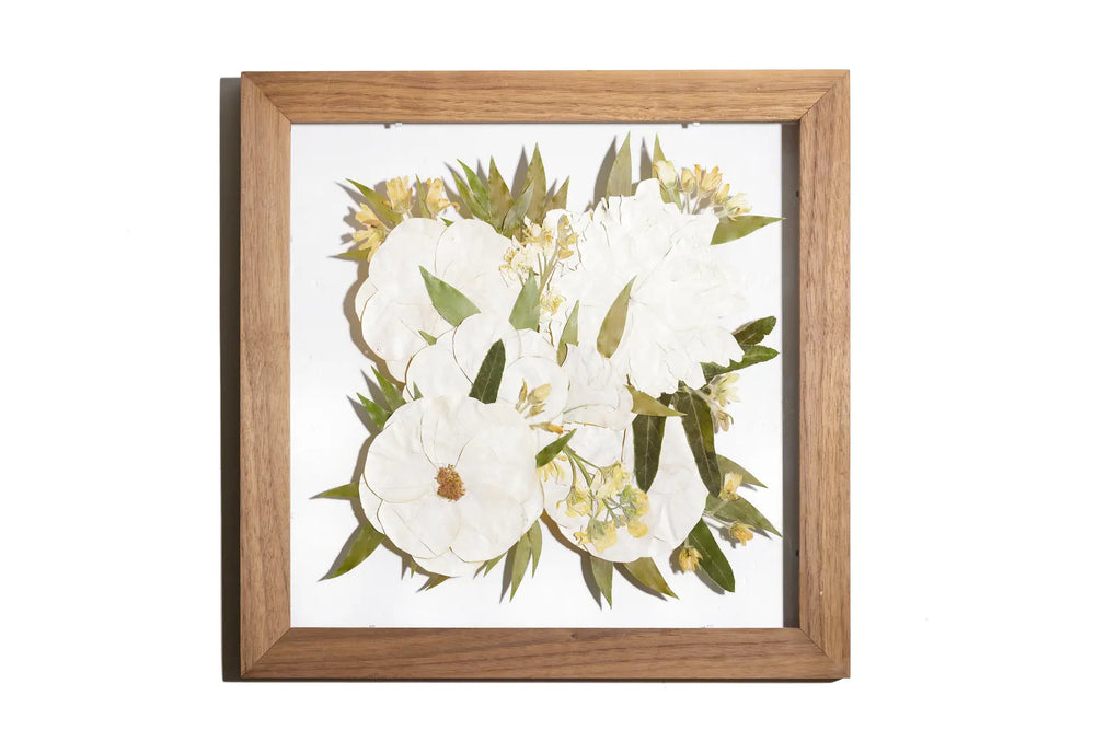 Pressed flower frame with teak stain wood and white bouquet of wedding flowers in a floating design
