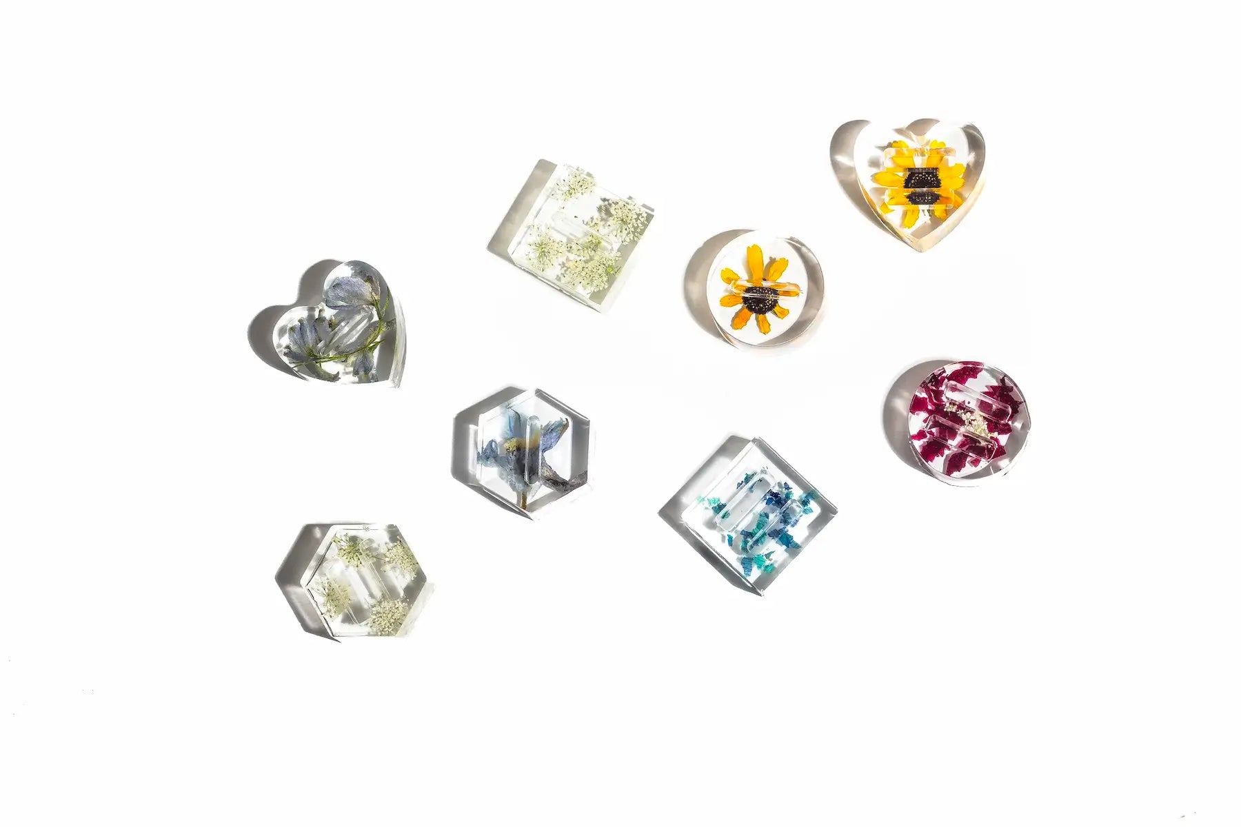 Ring dishes in shape of heart, circle, square, hexagon featuring colorful resin flowers.