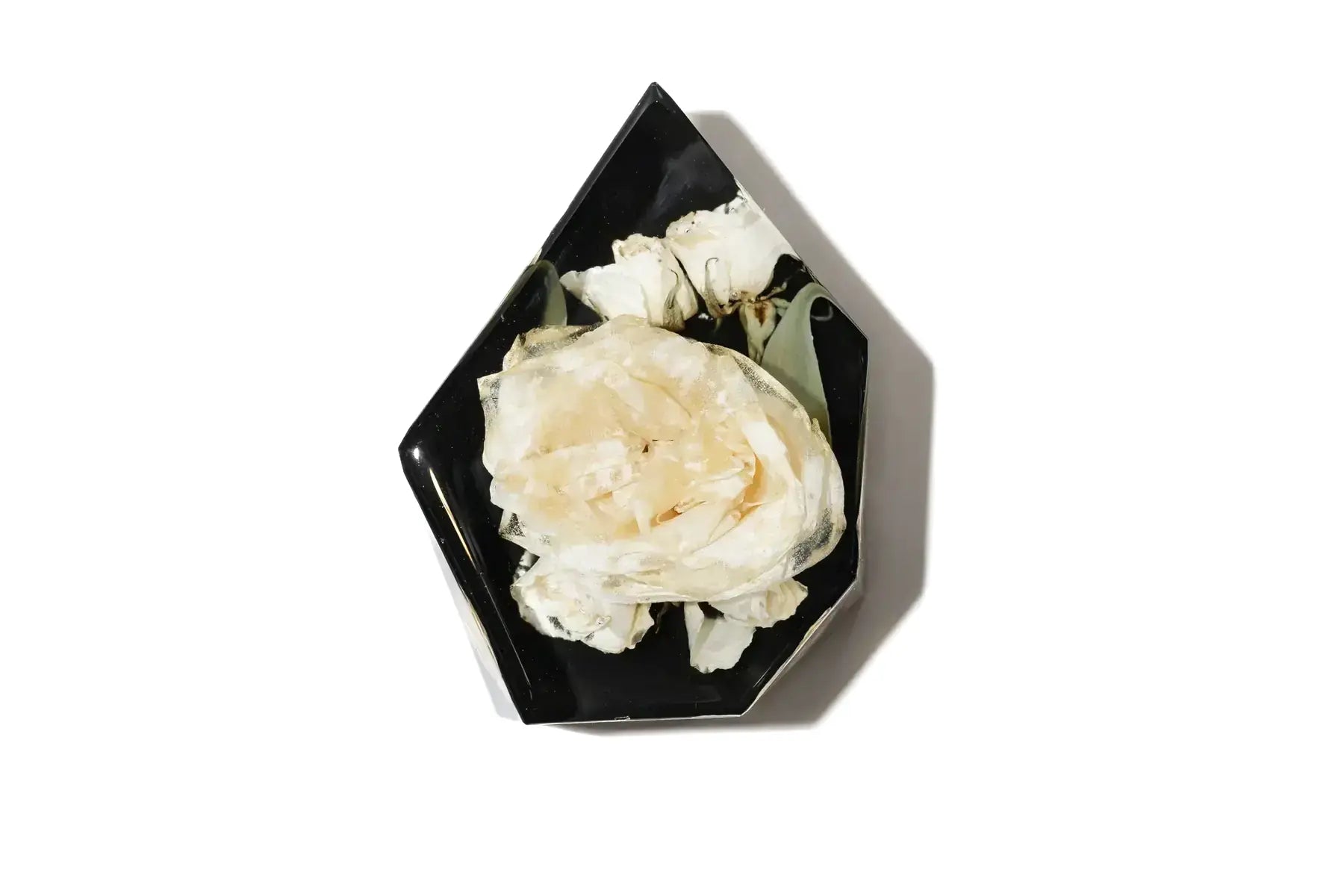 Hexagon bouquet block with a black resin background featuring a bouquet of white ranunculus flowers.