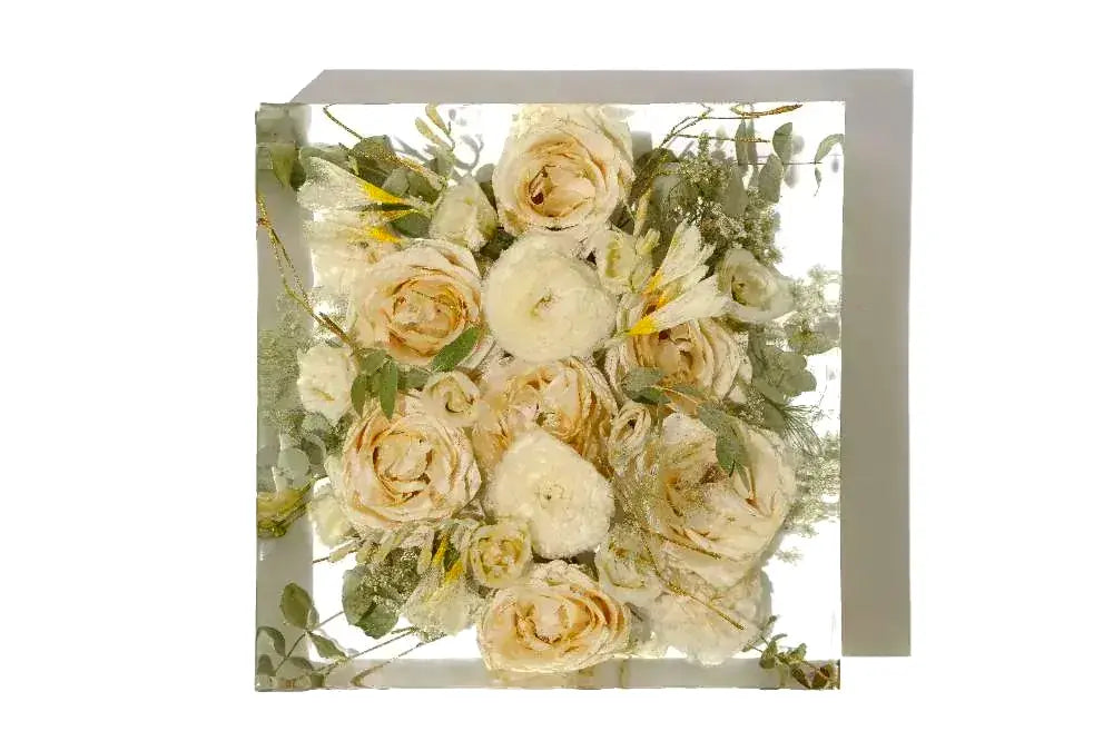 A small square 6 inch of ranunculus and roses preserved in clear resin.