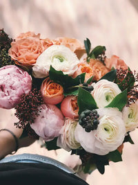 Bridal bouquet of roses and flowers with pink, white, and green colors.