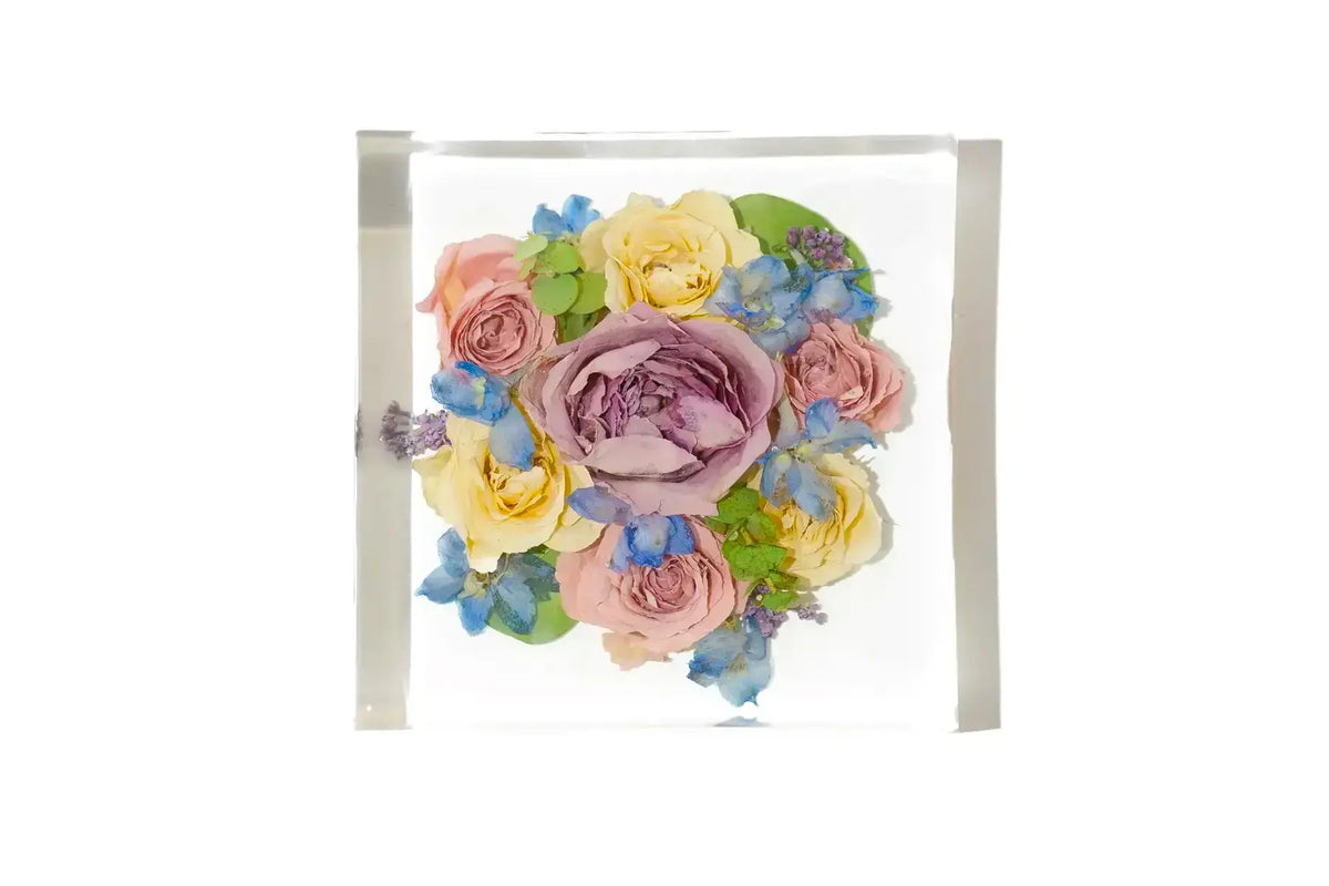 Springtime roses center arranged and resin preserved in a large square bouquet block.