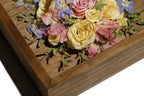 Preserved flowers in a wooden shadow box with a close-up view