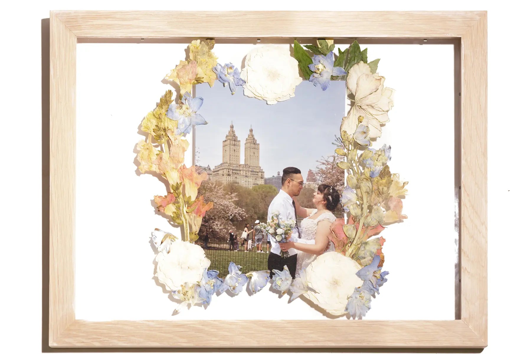 11x14 framed pressed flowers floating with a wedding photo from NYC in a natural wood frame