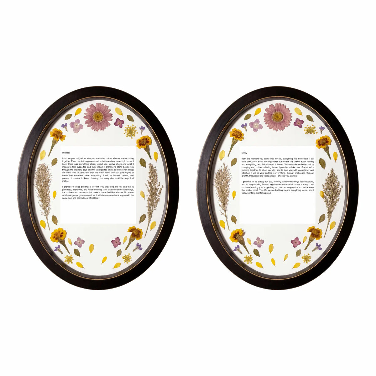 Two oval black wood pressed flower frames with wedding vows in the center surrounded by colorful bridal flowers.