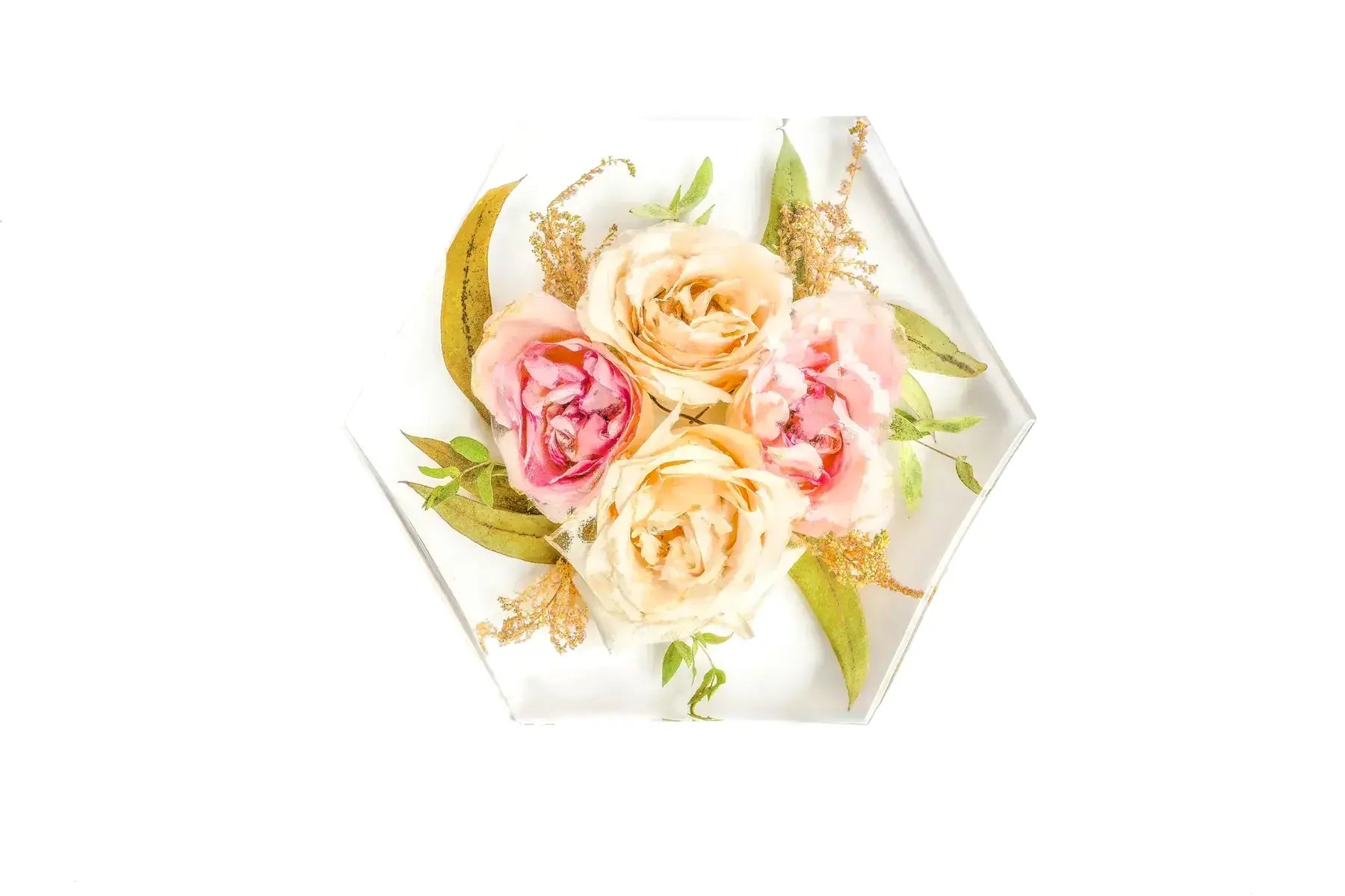 Four roses forever preserved in a clear resin bouquet block in a hexagonal shape.