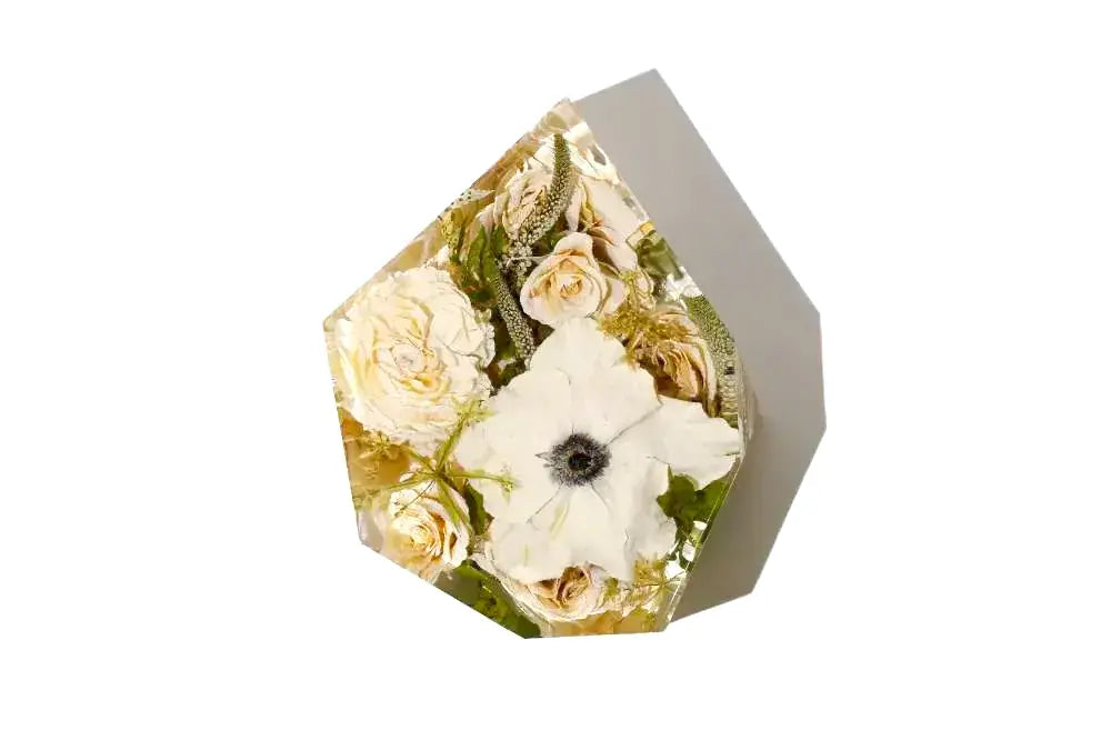 Gem shaped flower arrangement preservation in clear resin for wedding flowers.