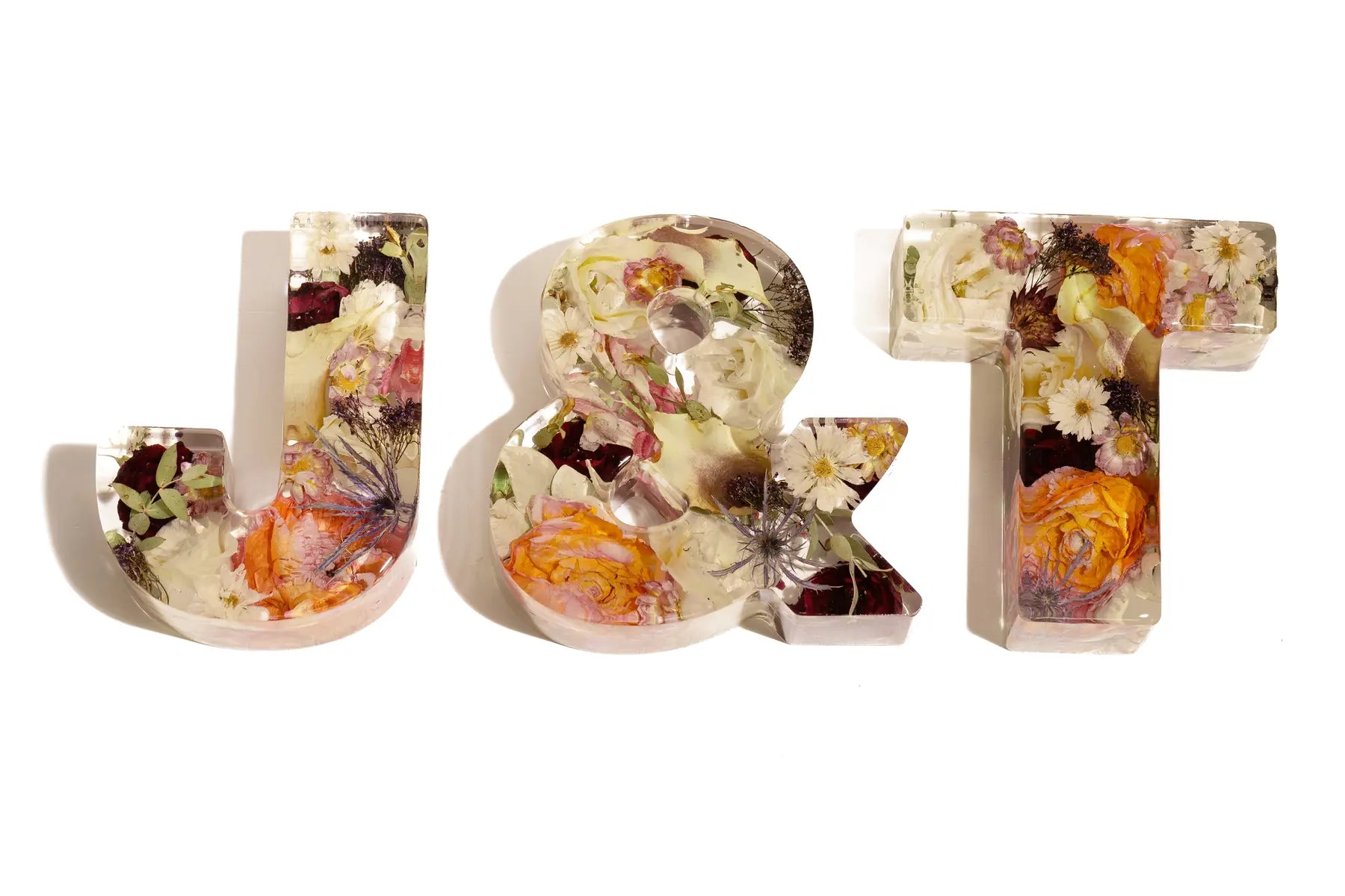 Decorative resin preserved letters 'J', '&, 'T' made of spring wedding flowers for a lasting keepsake