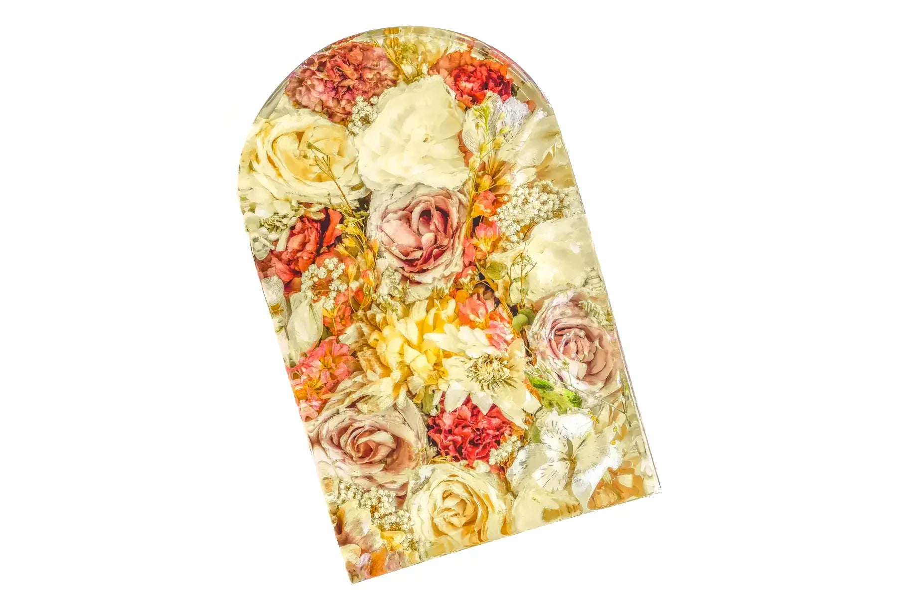 A large resin preservation bouquet block in an arch shape featuring an array of bright wedding flowers.