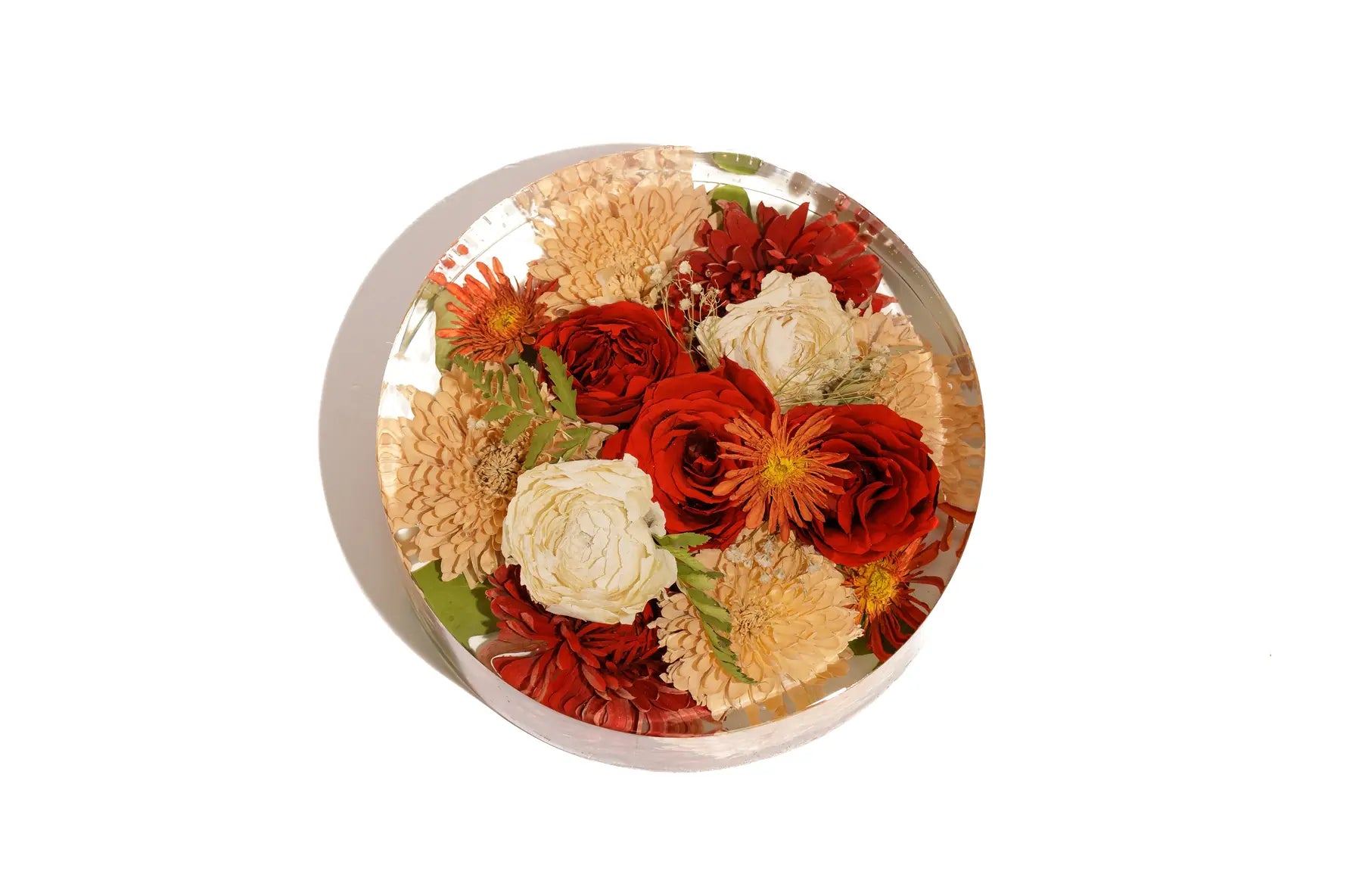 A 12 inch round bouquet block with resin preserved wedding roses and carnations.
