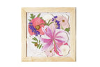 Framed artwork of pressed pink and purple flowers with no matboard and natural wood frame