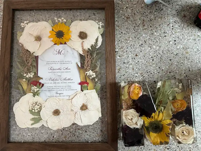 Decorative pressed frame with wedding flowers and wedding invitation with letter resin block