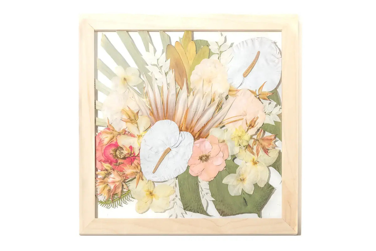 Springtime wedding flowers in a light brown wood frame