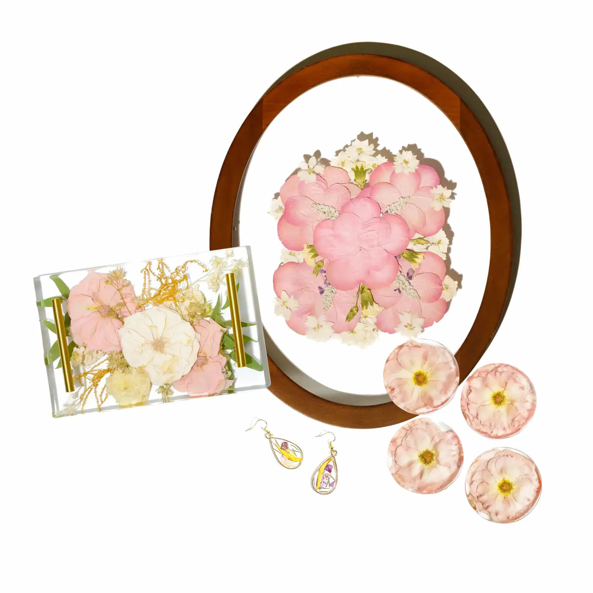 Set of preserved floral items including an oval pressed frame, resin floral tray, four resin coasters with individual flowers, and two pendant resin earrings.