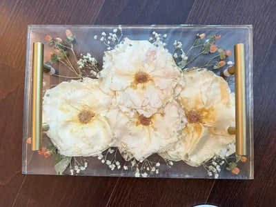 A large 11x14 resin tray with pressed white wedding flowers
