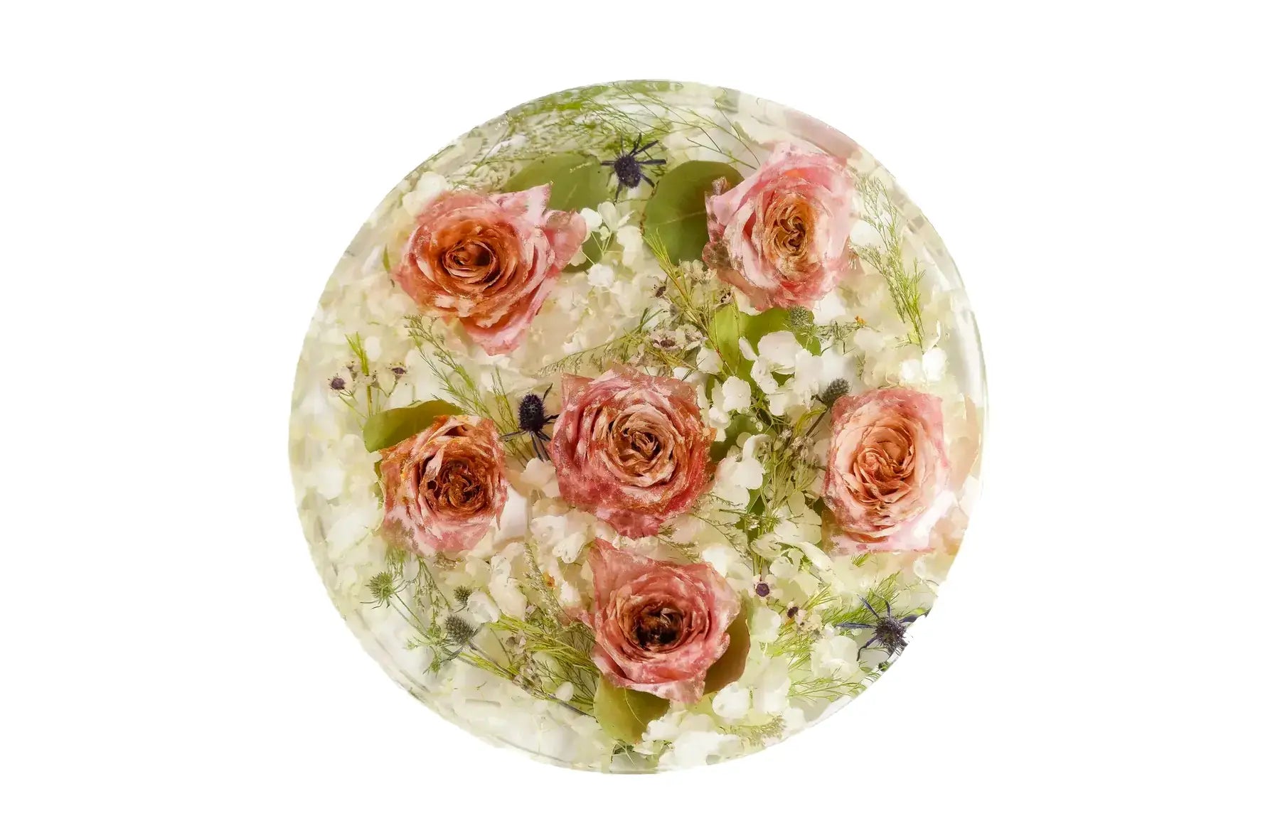 A rose filled bouquet of wedding flowers preserved in a 9 inch round clear resin block.