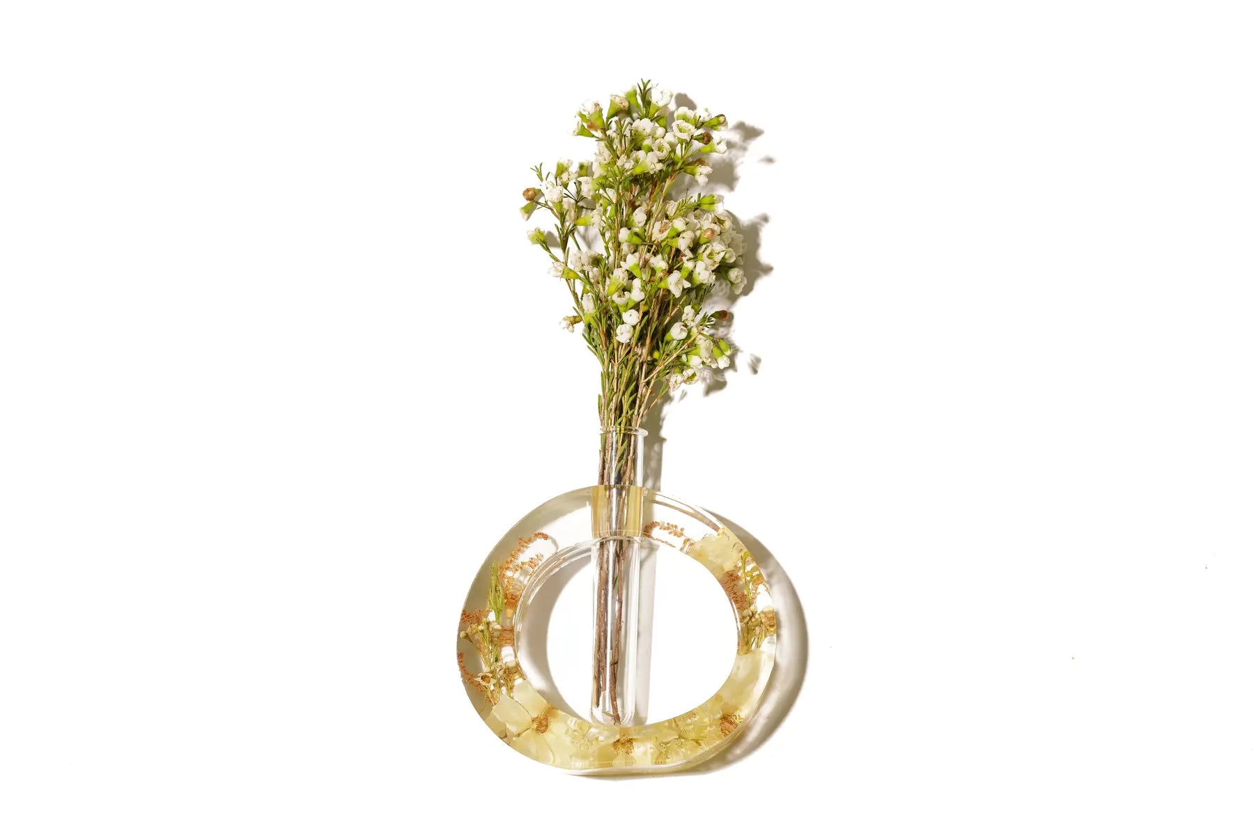 A round open circle flower vase made of wedding flowers preserved in resin.