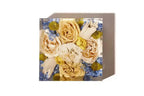 A 6 inch square bouquet block preserving peach and pink roses in a resin keepsake.