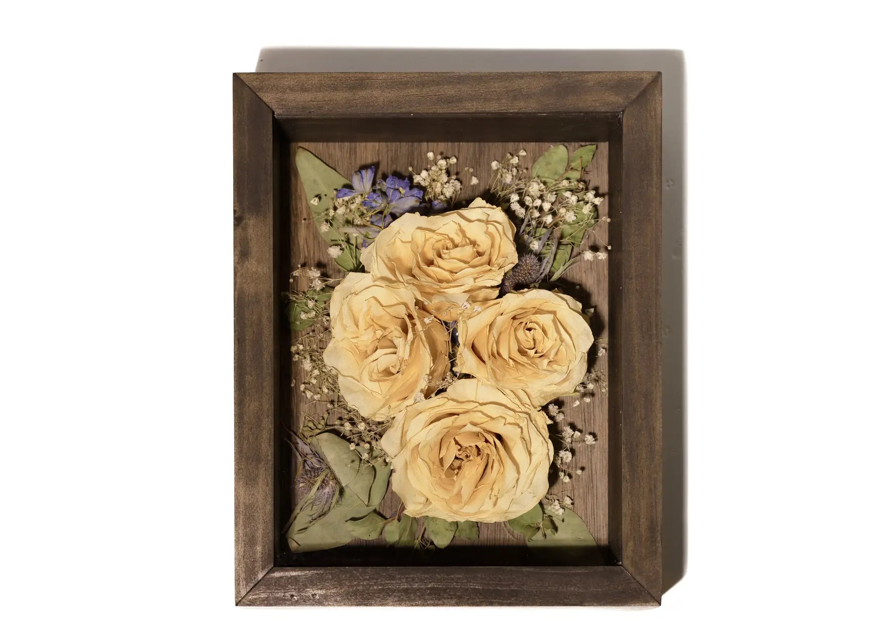 Decorative handmade wood shadow box with preserved yellow roses and greenery