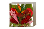 A colorful red arrangement of preserved resin flowers in a 6 inch bouquet block.