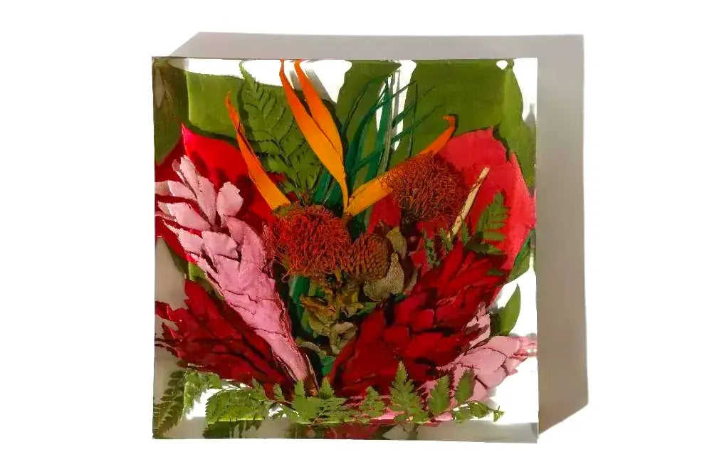 A colorful red arrangement of preserved resin flowers in a 6 inch bouquet block.