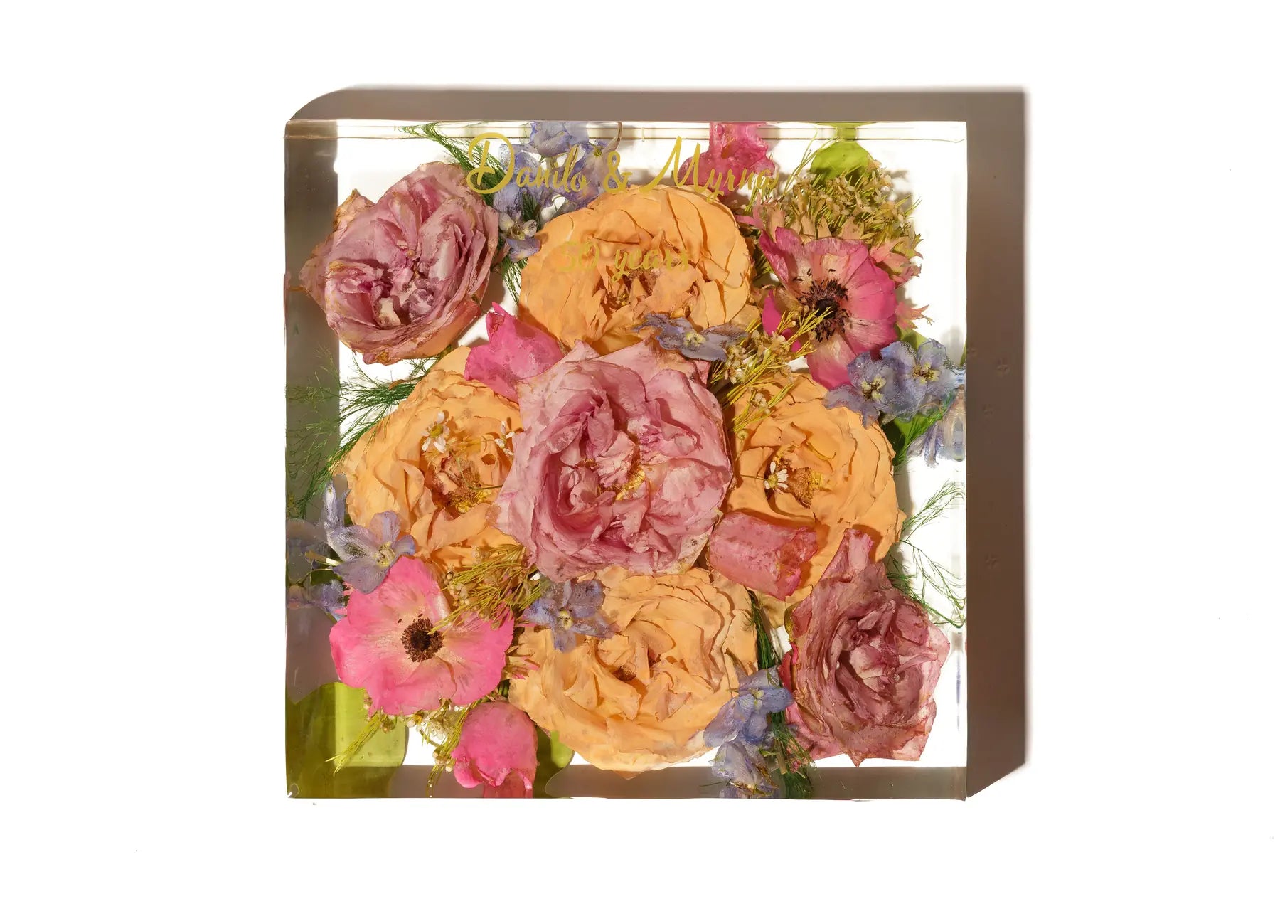 An 8 inch square resin bouquet block with custom vinyl lettering and preserved wedding flowers.