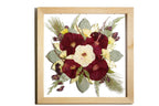 A square natural wooden frame with bright and autumnal wedding flowers in a floating design