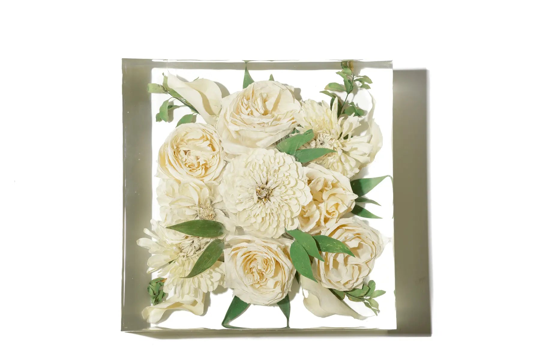 White dahlia and tea roses in a medium size resin bouquet block.