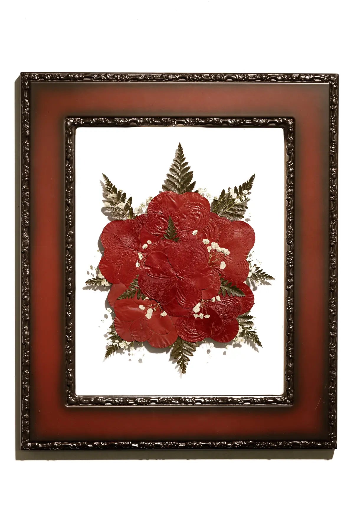 Framed pressed flowers with red roses with gold accents on a white background