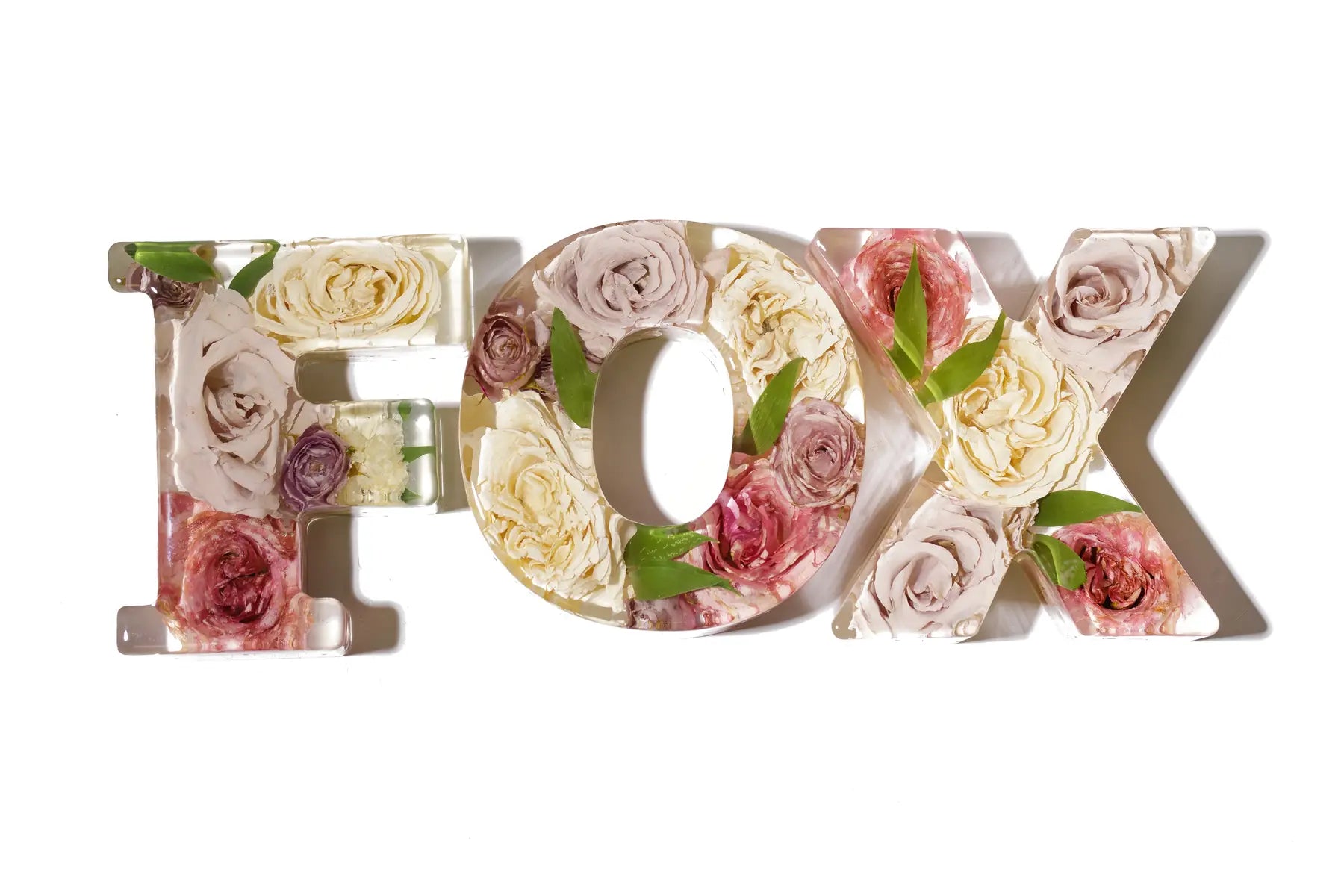 Decorative letters 'F' and 'O' and 'X' spelling 'FOX' made of resin preserved flowers