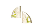 A pair of resin bookends with white orchid flowers sitting in a white space