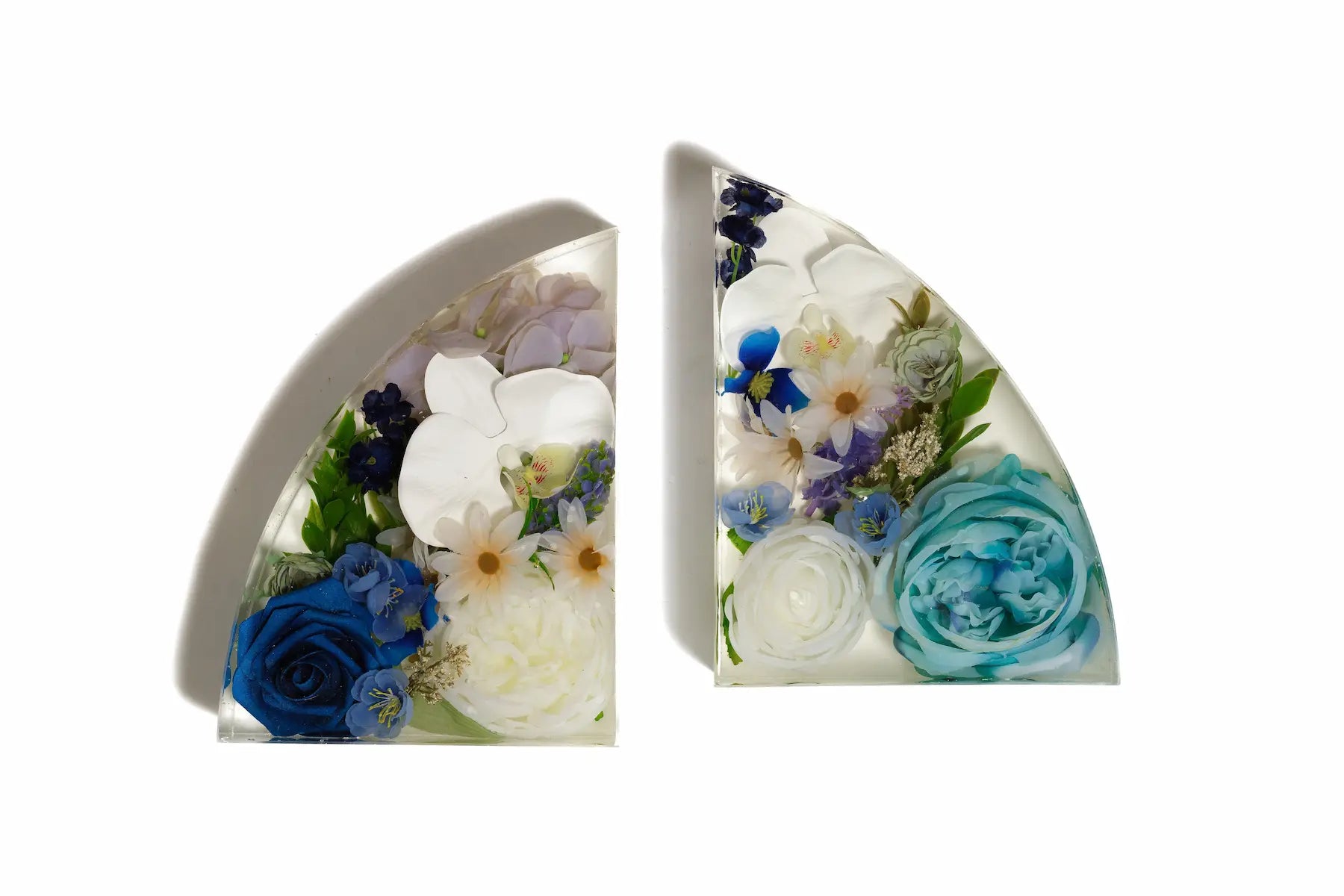 A diverse array of wedding flowers preserved in a set of resin bookends